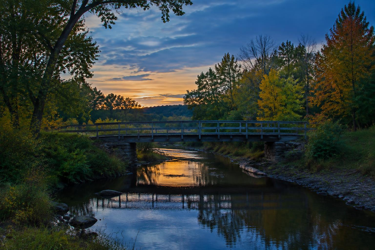 A small bridge crossing a Missouri creek between changing leaves
