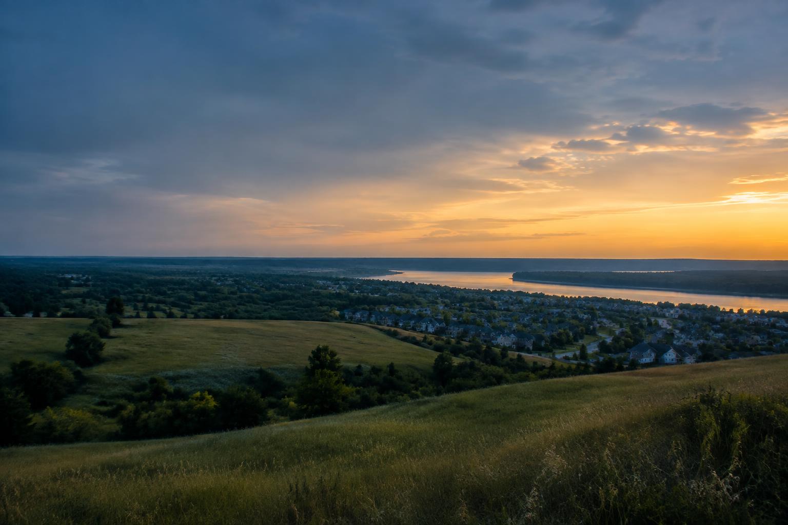 Rolling fields and neighborhoods near O'Fallon at sunset