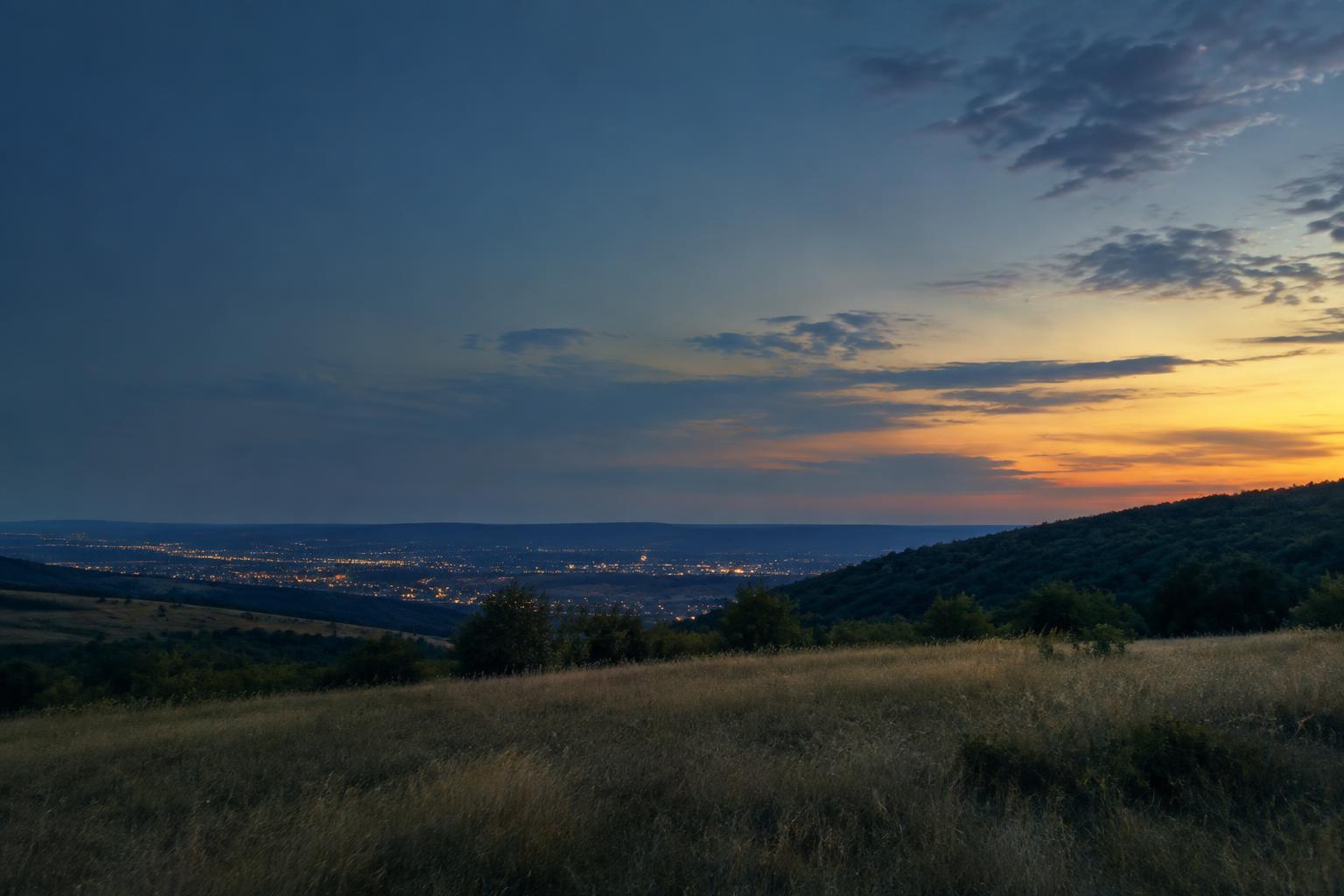 Wooded Ozarks hills overlooking Springfield at dusk